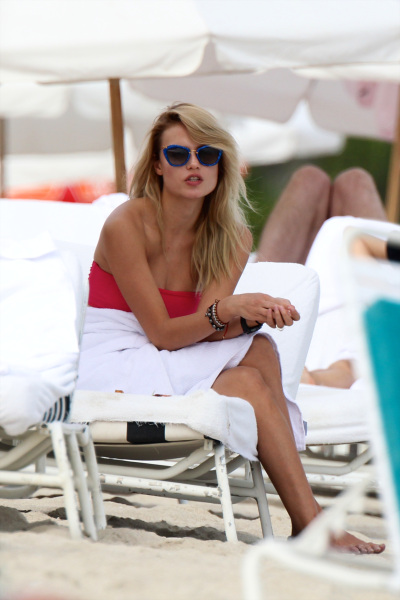 Supermodel Natasha Poly in a pink bandeau bikini at the beach in Miami