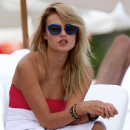 Supermodel Natasha Poly in a pink bandeau bikini at the beach in Miami