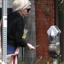 Anne Hathaway pets her seemingly pregnant friend's belly as the two have breakfast together in LA