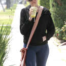 Anne Hathaway pets her seemingly pregnant friend's belly as the two have breakfast together in LA