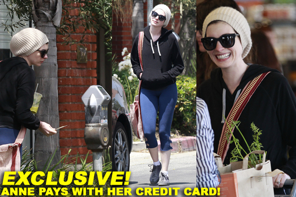 Anne Hathaway pets her seemingly pregnant friend's belly as the two have breakfast together in LA
