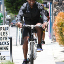 **EXCLUSIVE** Usher gives his best kung-fu move as he takes a bike ride along with a friend in Los Angeles