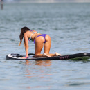Claudia Romani paddleboarding in a thong bikini in Miami