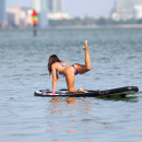 Claudia Romani paddleboarding in a thong bikini in Miami