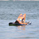 Claudia Romani paddleboarding in a thong bikini in Miami
