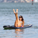 Claudia Romani paddleboarding in a thong bikini in Miami