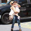 Sarah Michelle Gellar carries her little ballerina daughter Charlotte into her ballet class in Los Angeles