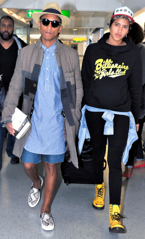 Rapper Pharrell Williams and his girlfriend fly out of Heathrow airport back to Los Angeles on September 4, 2013 in London