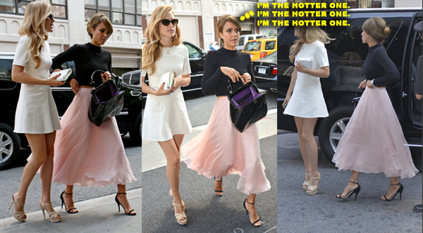Jessica Alba wears a long pink skirt and a black sweater as she heads into a building in New York City