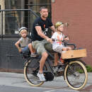 Naomi Watts & Liev Schreiber Tote Their Sons To School On Bikes