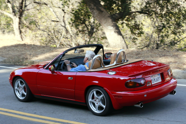 **EXCLUSIVE** Jay Leno drives a red supercharged Mazda Miata convertible while filming scenes for a commercial in LA