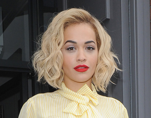 Rita Ora leaving a recording studio, wearing bright red trousers