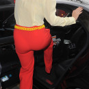 Rita Ora leaving a recording studio, wearing bright red trousers