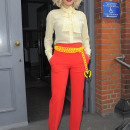 Rita Ora leaving a recording studio, wearing bright red trousers