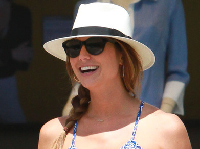Stacy Keibler shows off her growing baby bump in a long maxi dress as she shops in Los Angeles