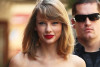 Taylor Swift Leggy At Night, But Covers Up While Out With Family