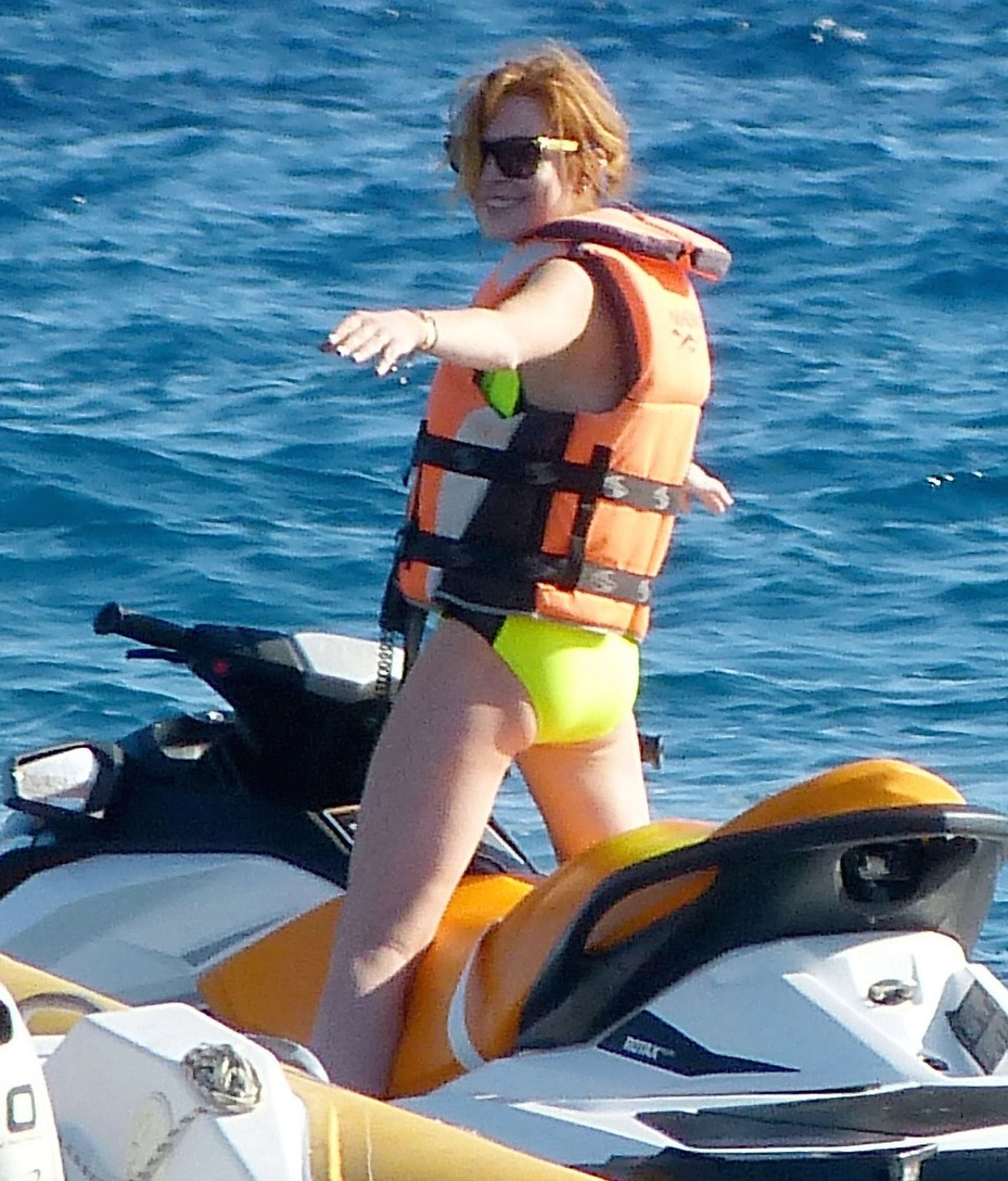 Lindsay Lohan puts safety first as she wears a lifejacket while riding jet skis in Ibiza